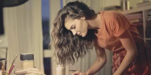 A girl focusing on a creative project in a studio setting