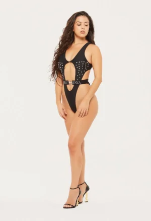 A woman models a black studded swimsuit